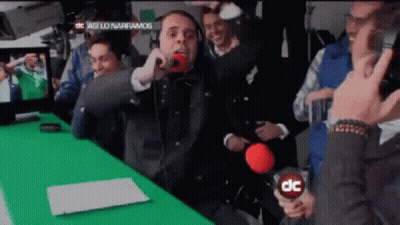 Man Holding Microphone In Front Of Green Screen Saying DC GIF