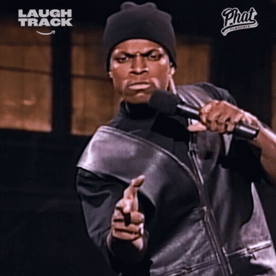 Man Holding Microphone In Front Of Laugh Track Sign GIF