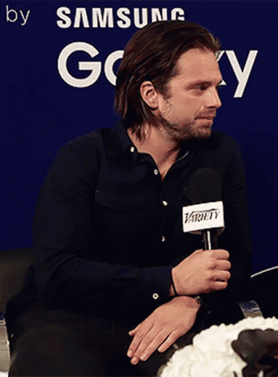 Man Holding Microphone In Front Of Samsung Sign GIF