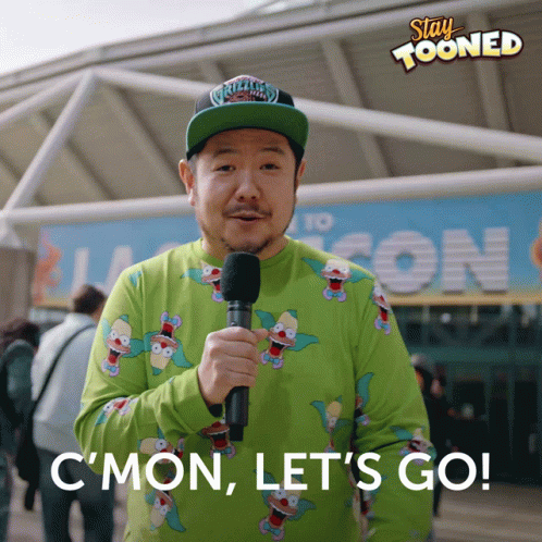 Man Holding Microphone In Front Of Stay Tooned Sign GIF