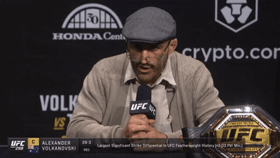 Man Holding Microphone In Front Of UFC Championship Belt GIF
