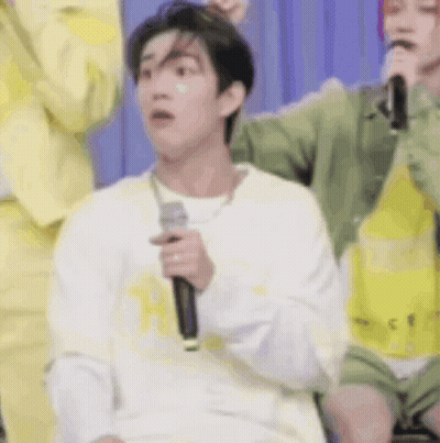 Man Holding Microphone Making Funny Face In Crowd GIF