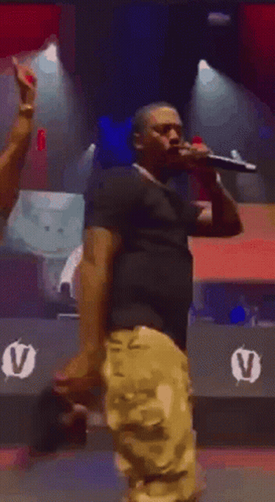 Man Holding Microphone On Stage GIF