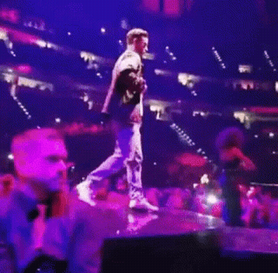 Man Holding Microphone On Stage GIF