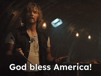 Man Holding Microphone Saying God Bless America GIF
