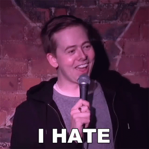 Man Holding Microphone Saying I Hate In Front Of Brick Wall GIF