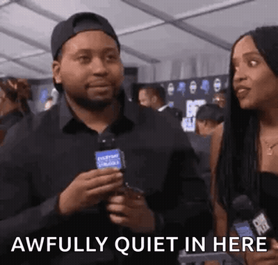 Man Holding Microphone Talking To Woman GIF