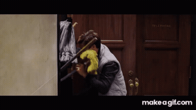 Man Holding Mop In Front Of Door Saying Telephone GIF
