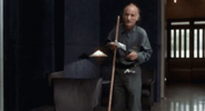 Man Holding Mop In Hallway GIF