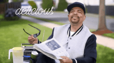 Man Holding Newspaper Saying Delicious GIF
