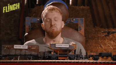 Man Holding Paintball Gun In Front Of Flinch Sign GIF