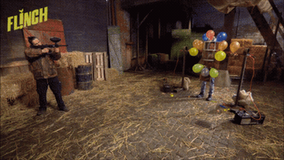 Man Holding Paintball Gun In Front Of Flinch Sign GIF