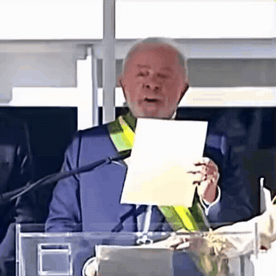 Man Holding Paper Giving Speech At Microphone GIF