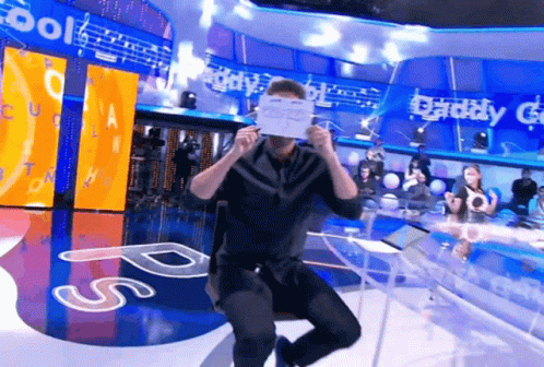 Man Holding Paper In Front Of Daddy G Sign GIF