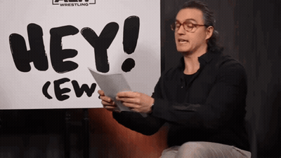 Man Holding Paper In Front Of Hey Sign GIF