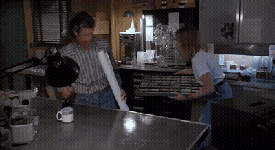 Man Holding Paper Woman With Tray In Kitchen GIF