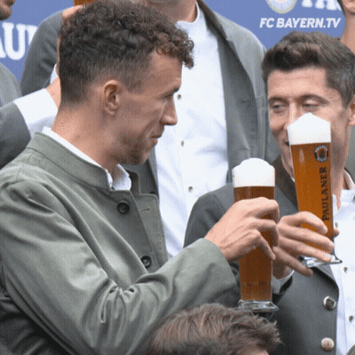 Man Holding Paulaner Beer At FC Bayern.tv Sign GIF