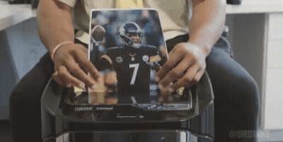 Man Holding Picture Of Football Player Number 7 Jersey GIF
