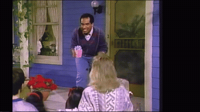 Man Holding Present At Blue House GIF