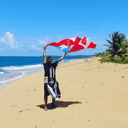 Man Holding Puerto Rico Flag At The Beach GIF