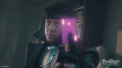 Man Holding Purple Object In Front Of Avengers Poster GIF