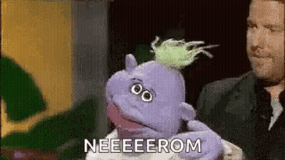 Man Holding Purple Puppet Saying Neeeeerom GIF