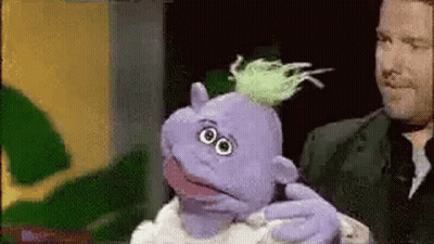 Man Holding Purple Puppet With Green Hair GIF