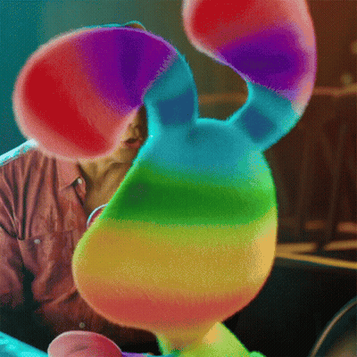 Man Holding Rainbow Stuffed Animal GIF