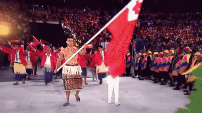 Man Holding Red And White Flag In Front Of Crowd GIF