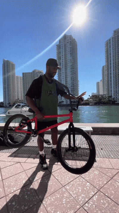 Man Holding Red BMX Bike GIF