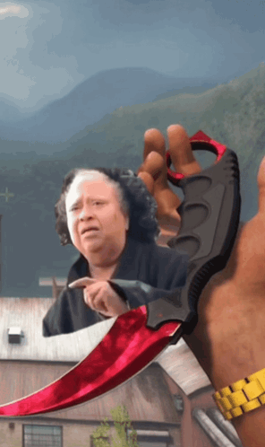 Man Holding Red Knife With Woman Behind GIF