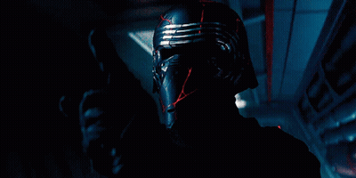 Man Holding Red Lightsaber With AT-ATs GIF