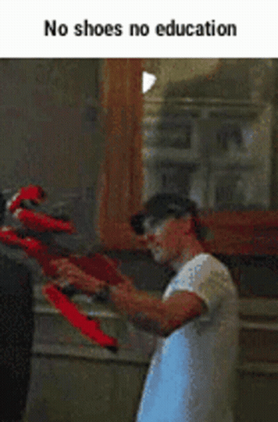 Man Holding Red Shoes GIF