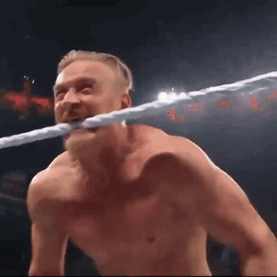 Man Holding Rope In Mouth In Wrestling Ring GIF
