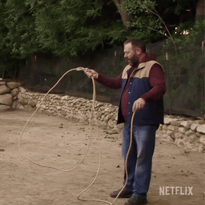 Man Holding Rope With Netflix Logo GIF