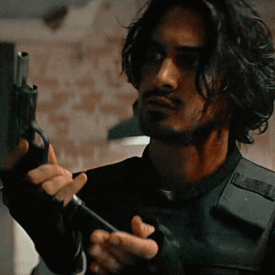Man Holding Shotgun In Front Of Resident Evil Sign GIF