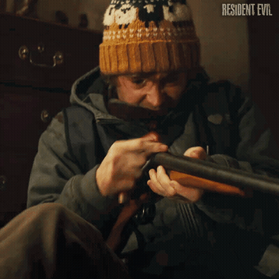 Man Holding Shotgun In Front Of Resident Evil Sign GIF