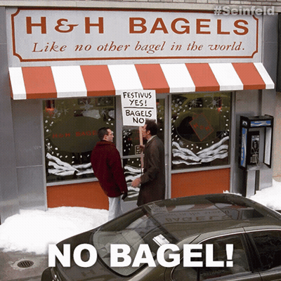 Man Holding Sign Saying Festivus Yes Bagel No GIF