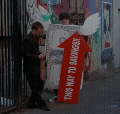 Man Holding Sign Saying This Way To Savings GIF