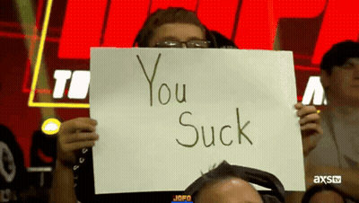 Man Holding Sign Saying You Suck GIF