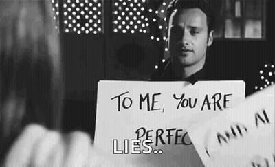Man Holding Sign That Says You Are Perfect Lies GIF