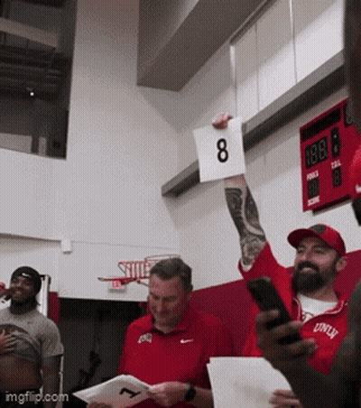 Man Holding Sign With Number 8 GIF
