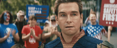 Man Holding Signs In Crowd GIF