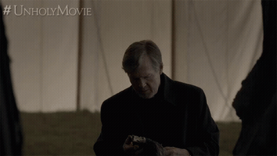 Man Holding Skull In Front Of Tent #Unholymovie GIF