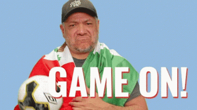 Man Holding Soccer Ball With Game On GIF