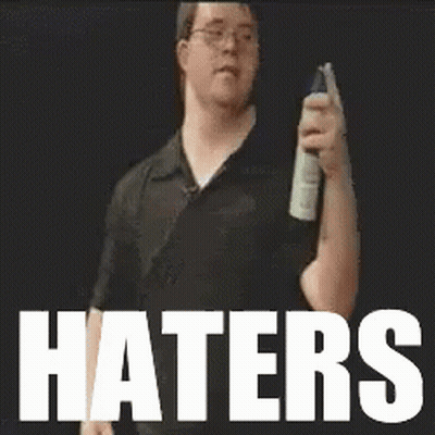 Man Holding Spray Bottle in Front of Haters