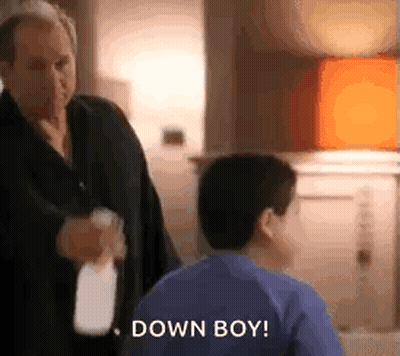Man Holding Spray Bottle Next To Boy GIF
