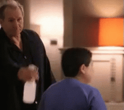 Man Holding Spray Bottle Talking To Boy GIF