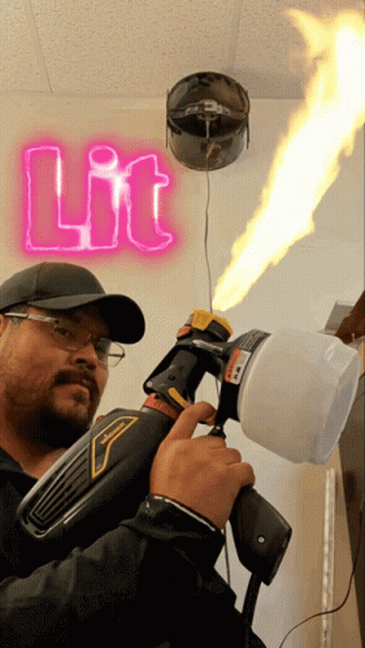 Man Holding Spray Gun In Front Of Neon Sign GIF