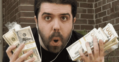 Man Holding Stack Of 100 Dollar Bills In Front Of Brick Wall GIF